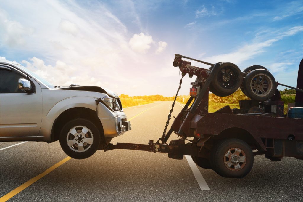 a White SUV being towed